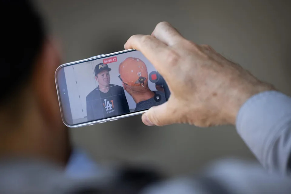A person films an interaction with mayoral candidate Spencer Pratt