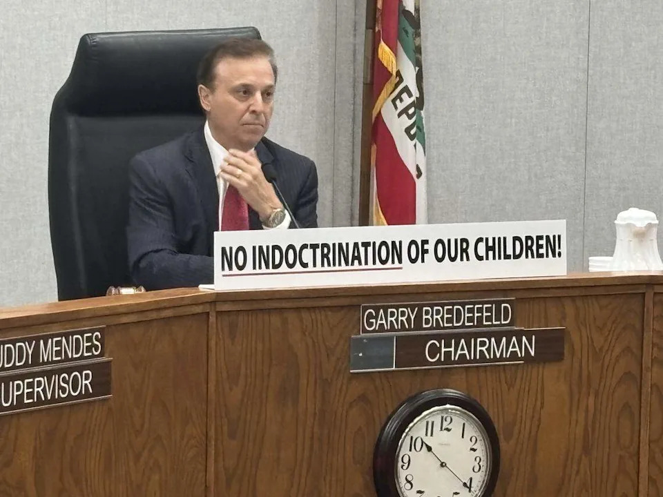 Fresno County Supervisor Garry Bredefeld put a sign on the dais on Tuesday before he voted against allowing the library to participate in Pride Month, and restricting some displays by the library.