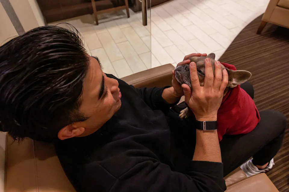 Dr. Brian Baliwas pets Xylo, the therapy dog at 450 Aesthetics Dental Group in San Francisco. (Chris Partin/Special to SFGATE)