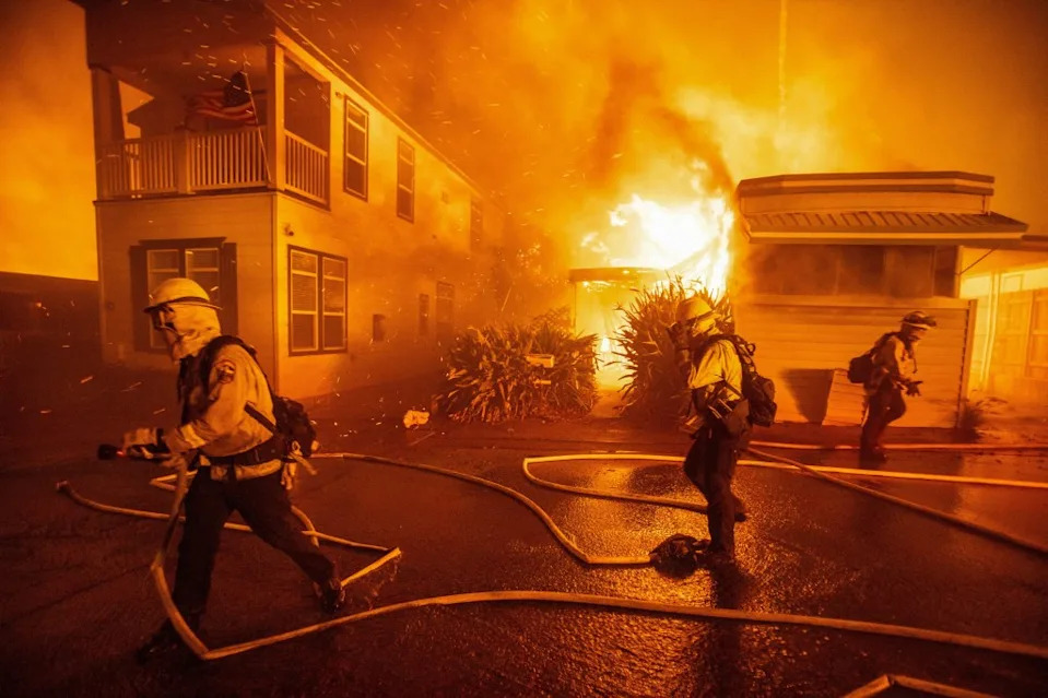 Firefighters battle the Palisades Fire. REUTERS