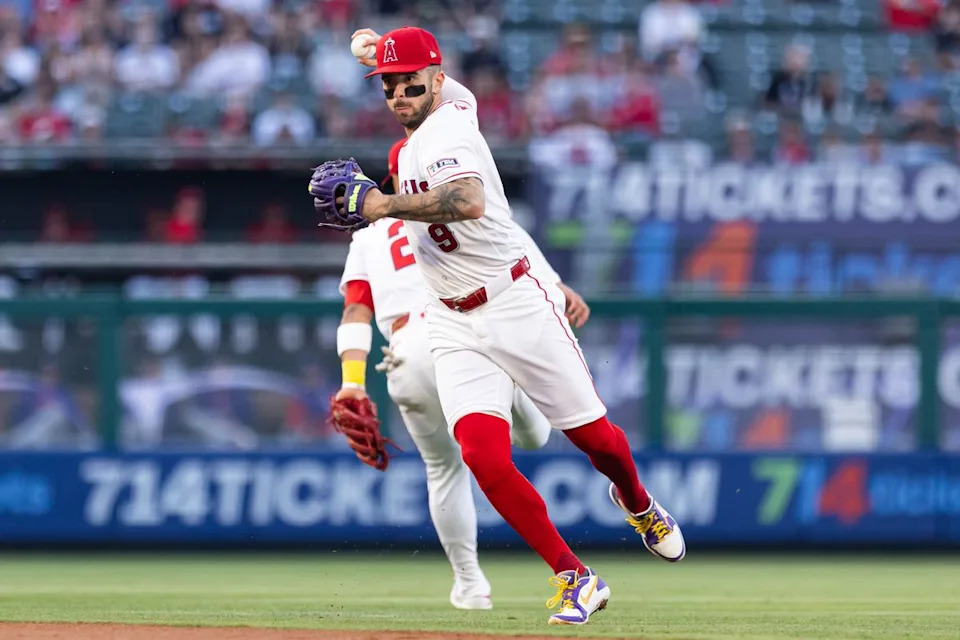Zach Neto #9 of the Los Angeles Angels throws the ball to first base during an MLB game against the Texas Rangers on May 23, 2026 at Angel Stadium in Anaheim, California.