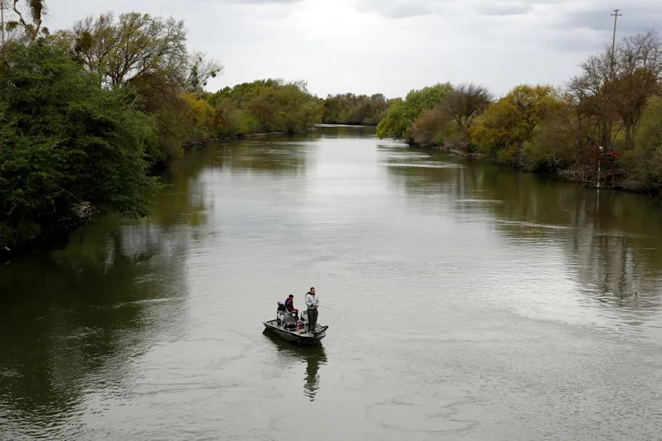 People fish in the Sacramento-San Joaquin River Delta’s Elk Slough near Courtland, California, in 2020.