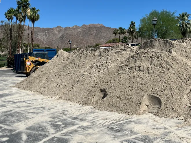 Sand that will be used to renovate bunkers on the North Course at Ironwood Country Club in Palm Desert is piled on part of the parking lot of the club's clubhouse. The renovation of the bunkers and more will last throughout the summer.