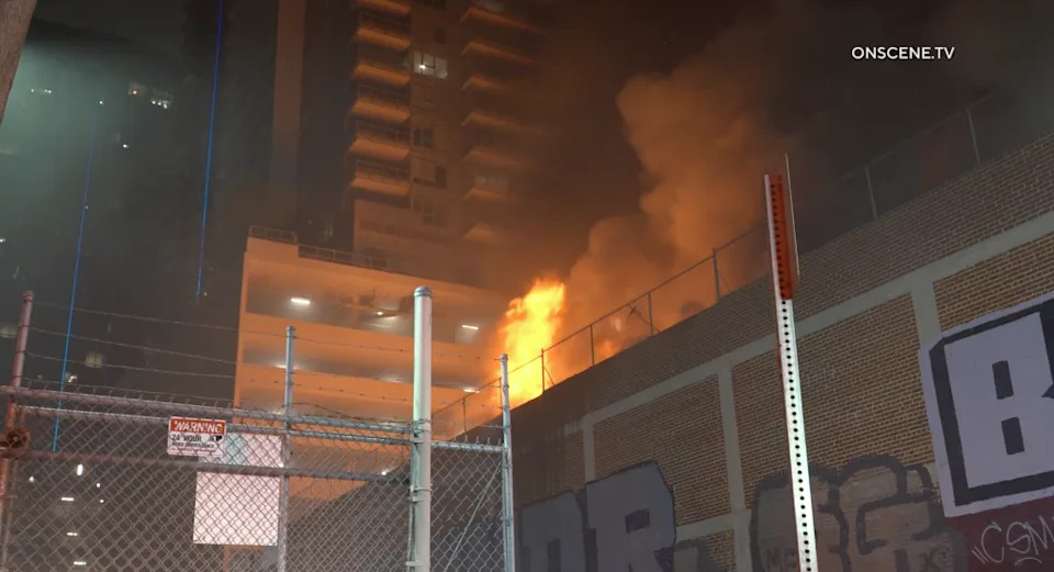 The flames and smoke caused at least two nearby high-rise apartment buildings to be evacuated.