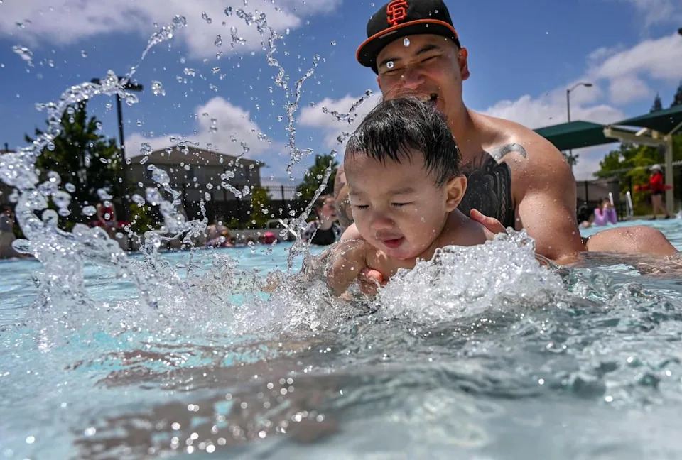 Eight-month-old Antonio Muñoz splashes in the wading pool with his dad Emmanuel Muñoz of Sacramento at the grand opening of the Pat O’Brien Community Center and aquatic center in 2019.