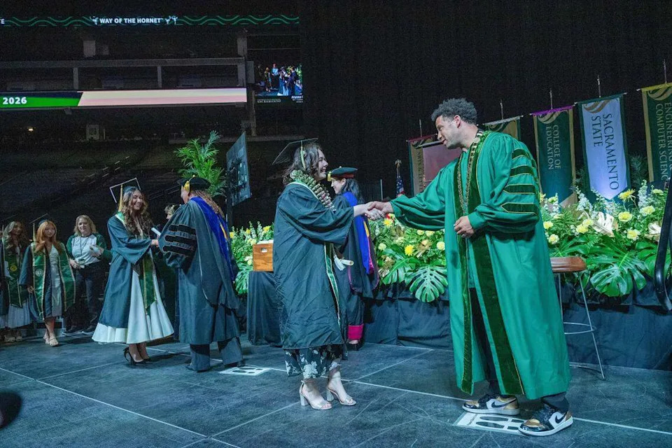 Sacramento State President Luke Wood greets graduates after they receive their diplomas at Golden 1 Center during one of the school's commencement ceremonies at Golden 1 Center on Friday. The university is celebrating the largest graduating class in its history.