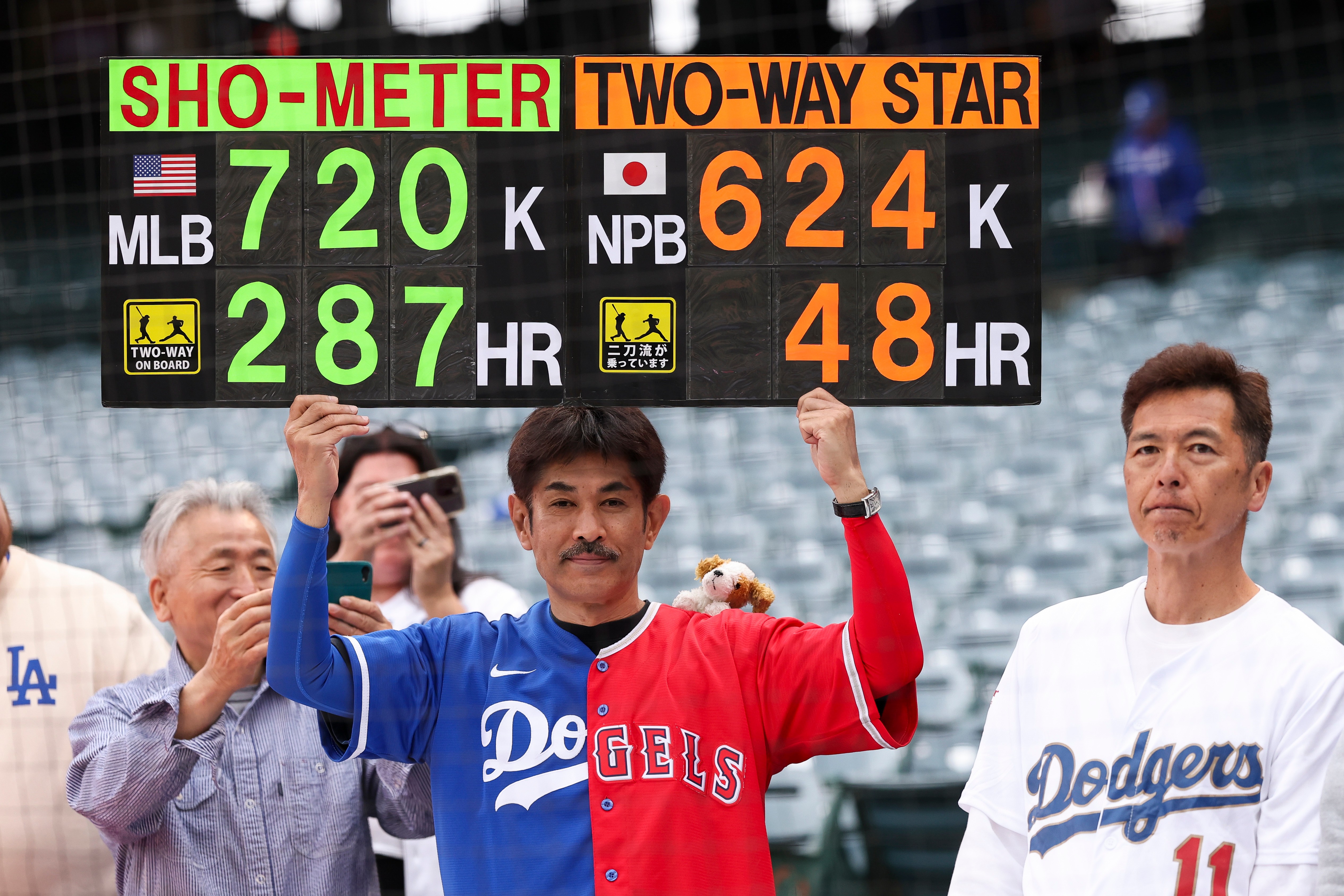A fan holds up a sign for Dodgers’ Shohei Ohtani...