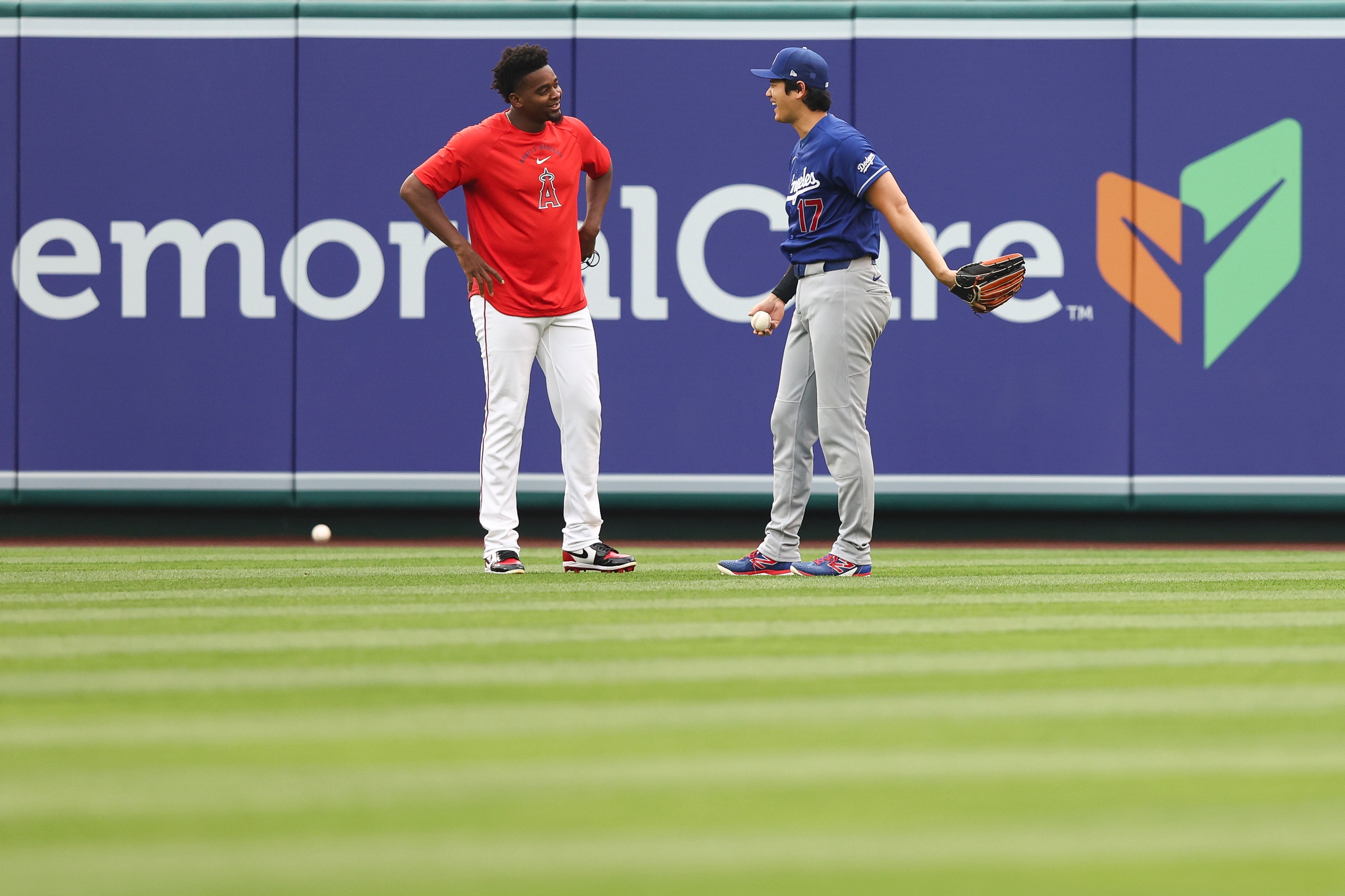 Dodgers’ Shohei Ohtani, right, and Angels’ José Soriano, left, interact...