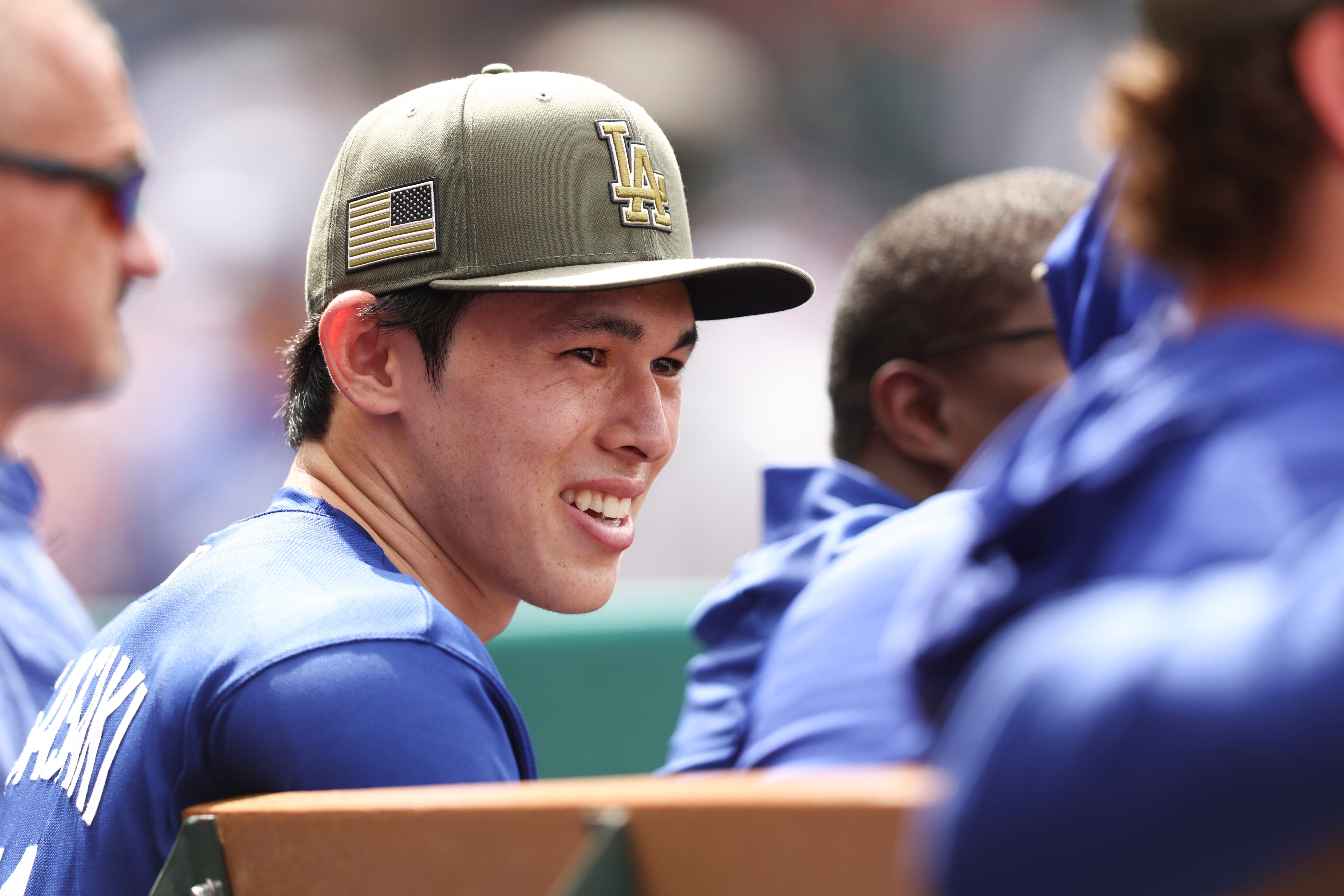 Dodgers pitcher Roki Sasaki reacts in the dugout during the...