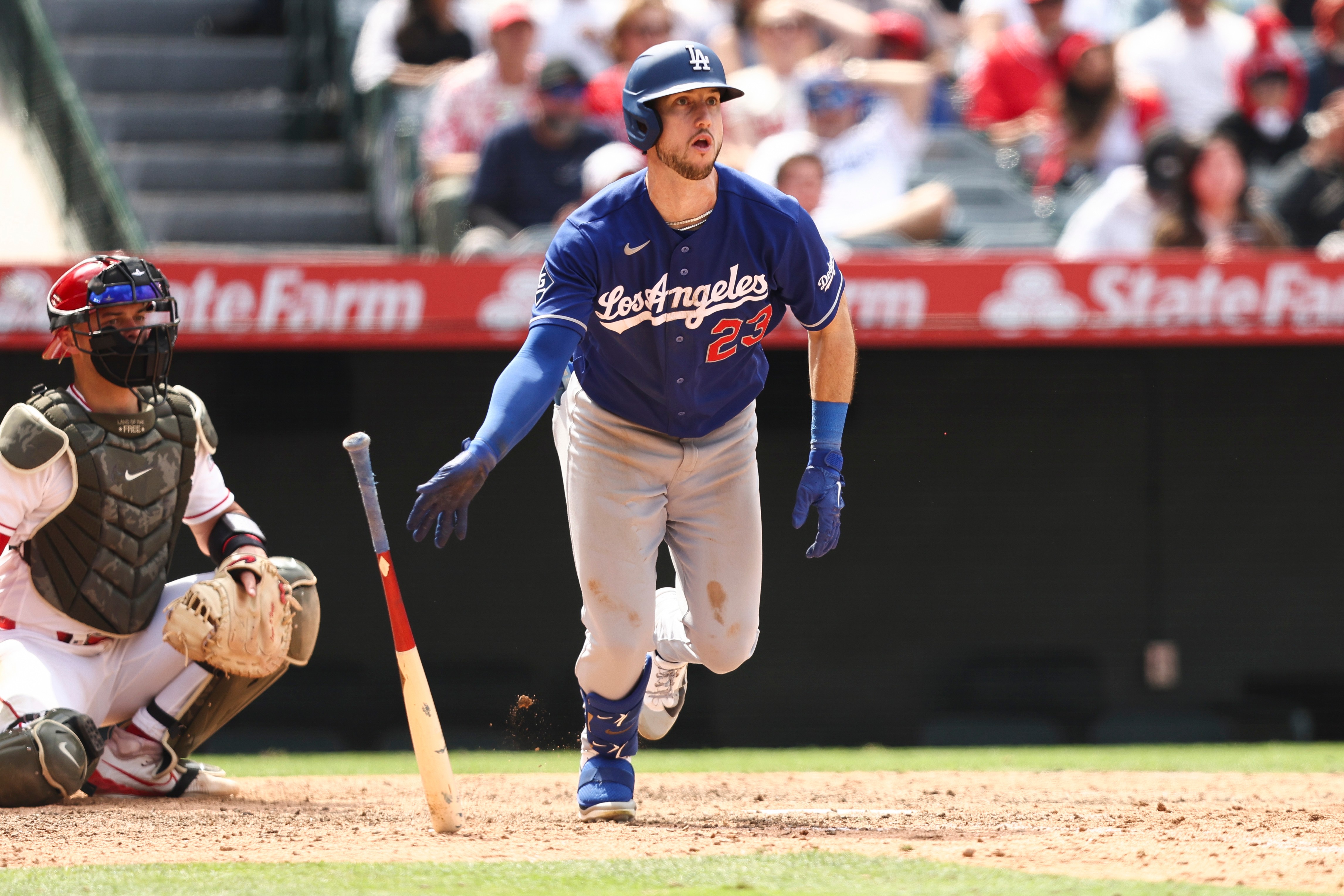 Dodgers’ Kyle Tucker drops his bat after hitting an RBI...