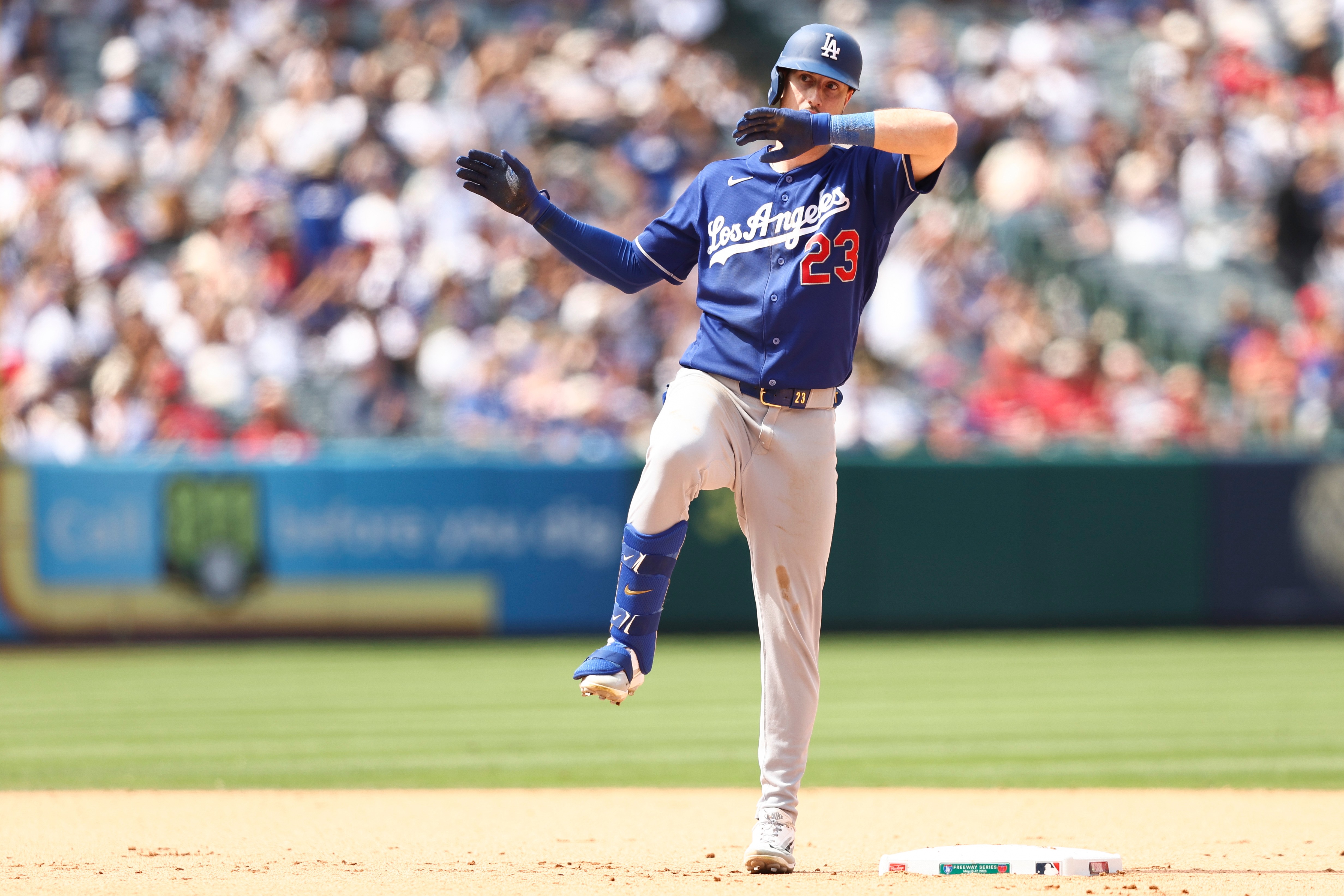 Dodgers’ Kyle Tucker gestures on second base after hitting an...