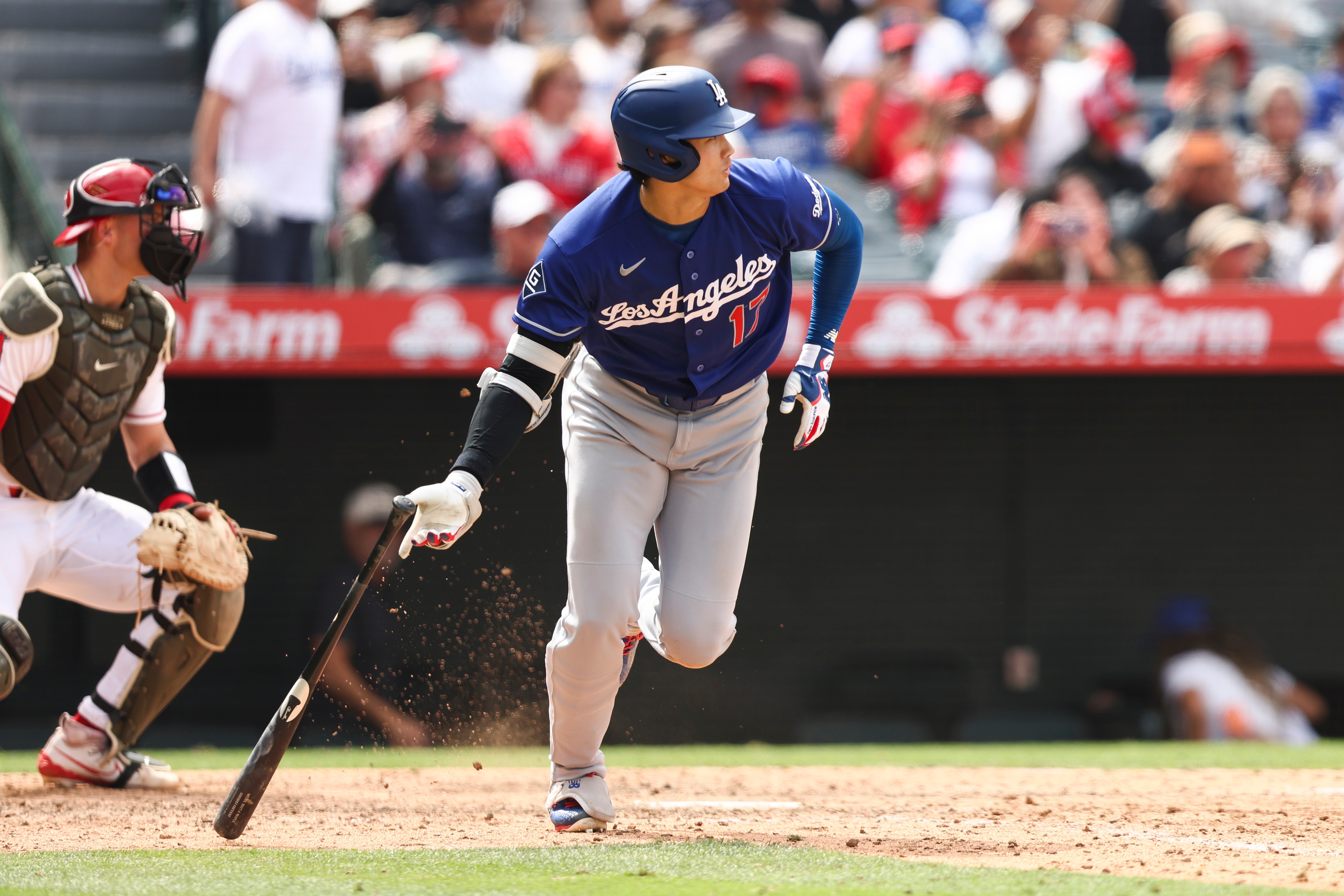 Dodgers’ Shohei Ohtani drops his bat after hitting a single...