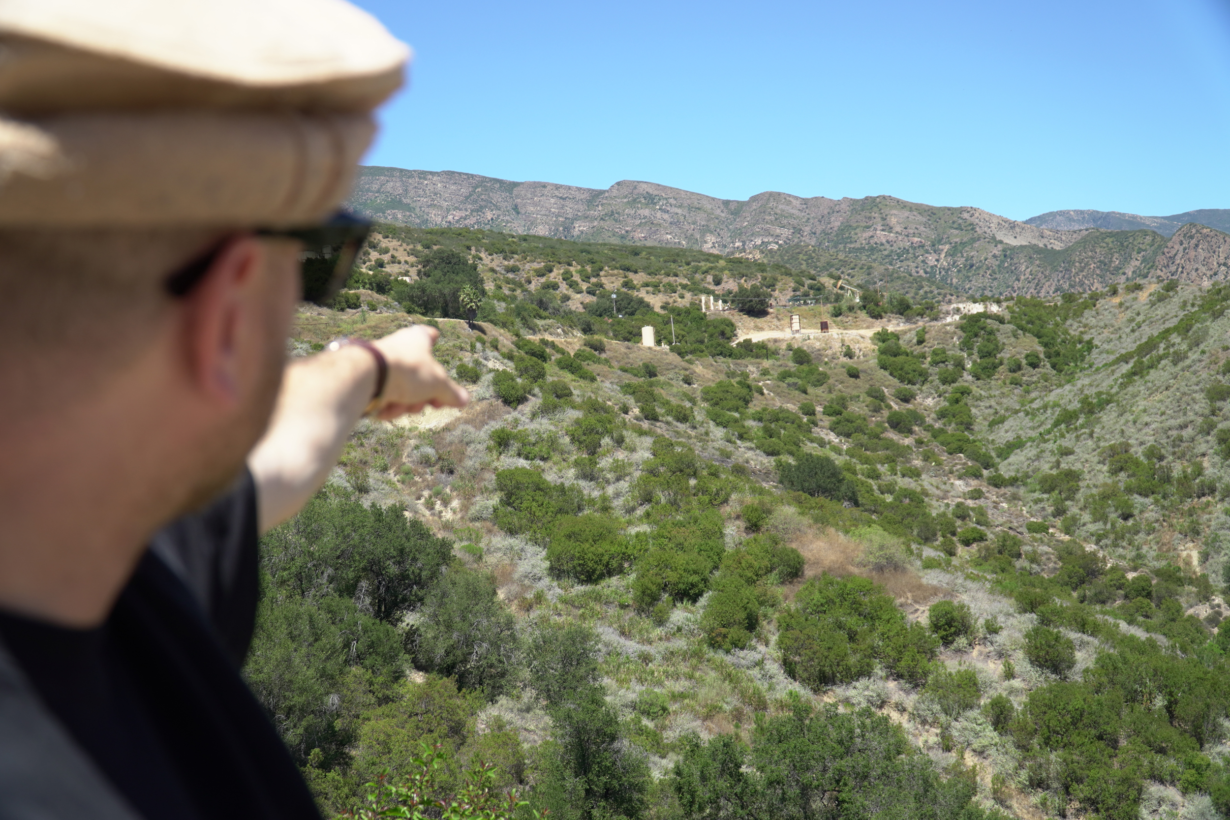 Ethan Higbee points to the area where the oil spill originated. Credit: Steven Rodas/Inside Climate News