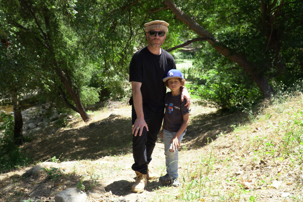 Ethan Higbee stands with his 6-year-old son, Noah, in the area where the spill took place six months earlier. Credit: Steven Rodas/Inside Climate News