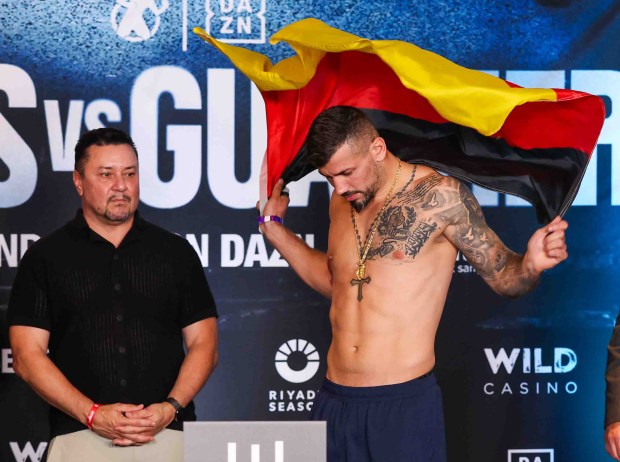 Vincenzo Gualtieri, of Germany, puts his national flag on his shoulder as he steps onto the scale during an official weigh-in ahead of his fight against Amari Jones, of Oakland, at the Hayes Mansion in San Jose, Calif., Thursday, May 21, 2026. Jones, an undefeated middleweight contender, and Gualtieri, a former IBF middleweight world champion, will fight in a 12-round IBF title eliminator bout on Friday at the SAP Center in San Jose. (Ray Chavez/Bay Area News Group)