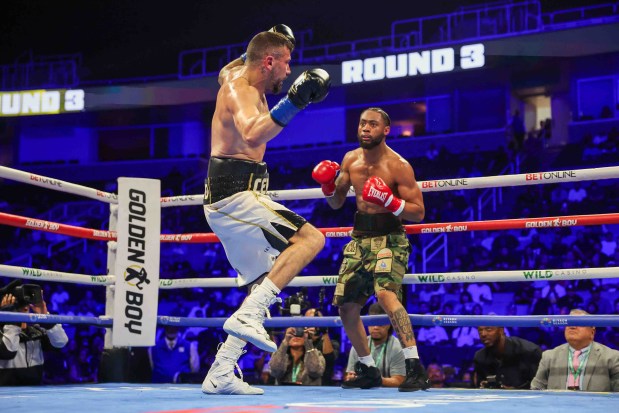 Vincenzo Gualtieri, of Germany, loses his balance after Amari Jones, of Oakland, left, landed a punch that led to a knockdown during the third round of their 12-round IBF title eliminator bout at the SAP Center in San Jose, Calif., Friday, May 22, 2026. Jones won by knockout in the third round. (Ray Chavez/Bay Area News Group)