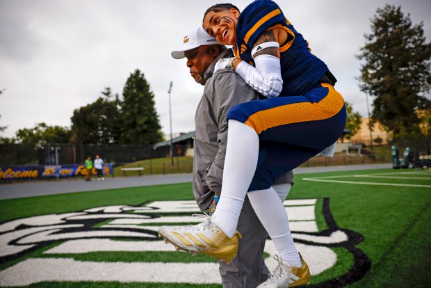 Golden State Storm's Lex Contreras (17) jumps on Golden State Storm's running back coach K.C. Adams at Laney College in Oakland, Calif., on Sunday, May 3, 2026. (Shae Hammond/Bay Area News Group)