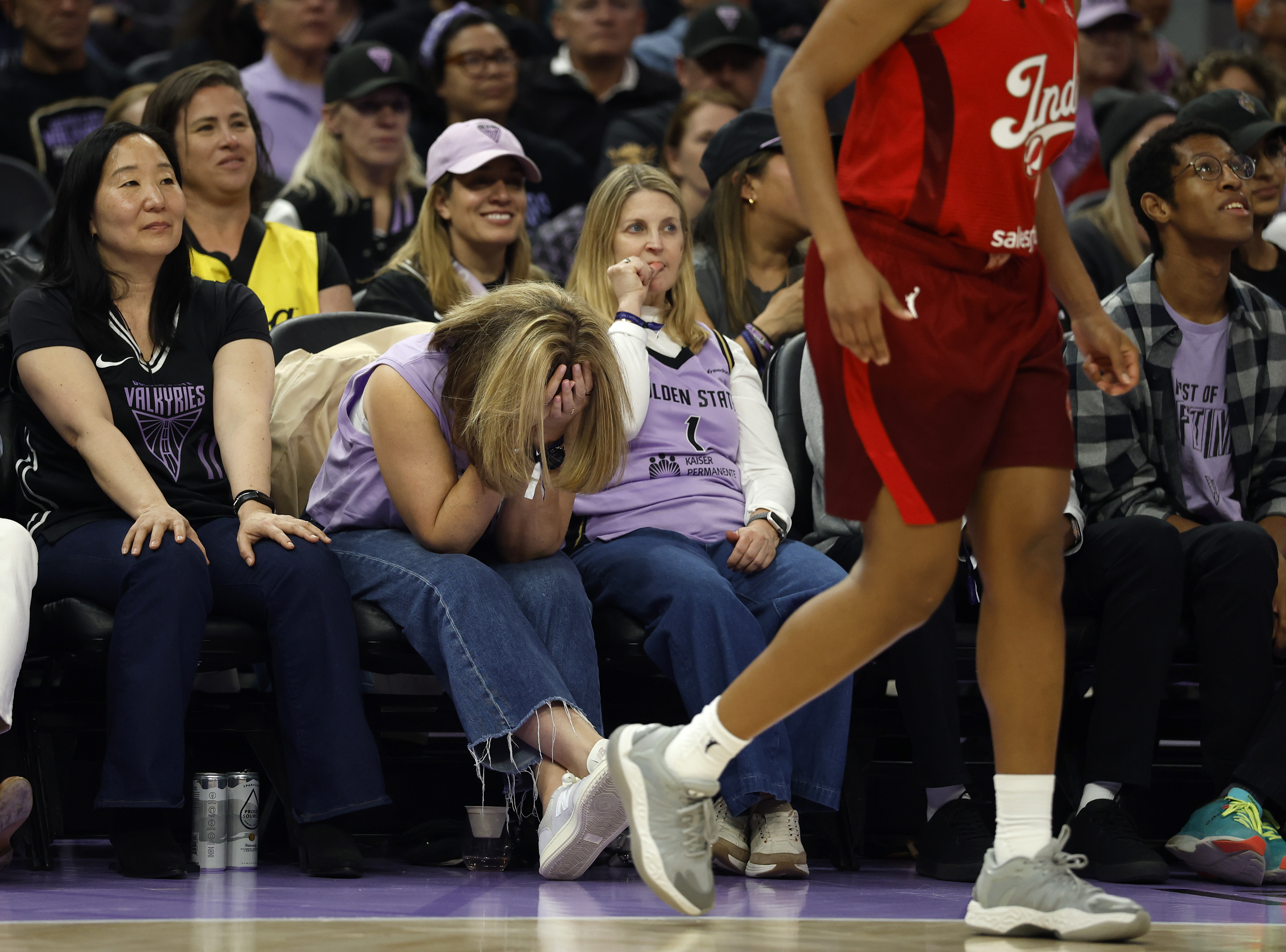 A Golden State Valkyries fan reacts to a basket and...