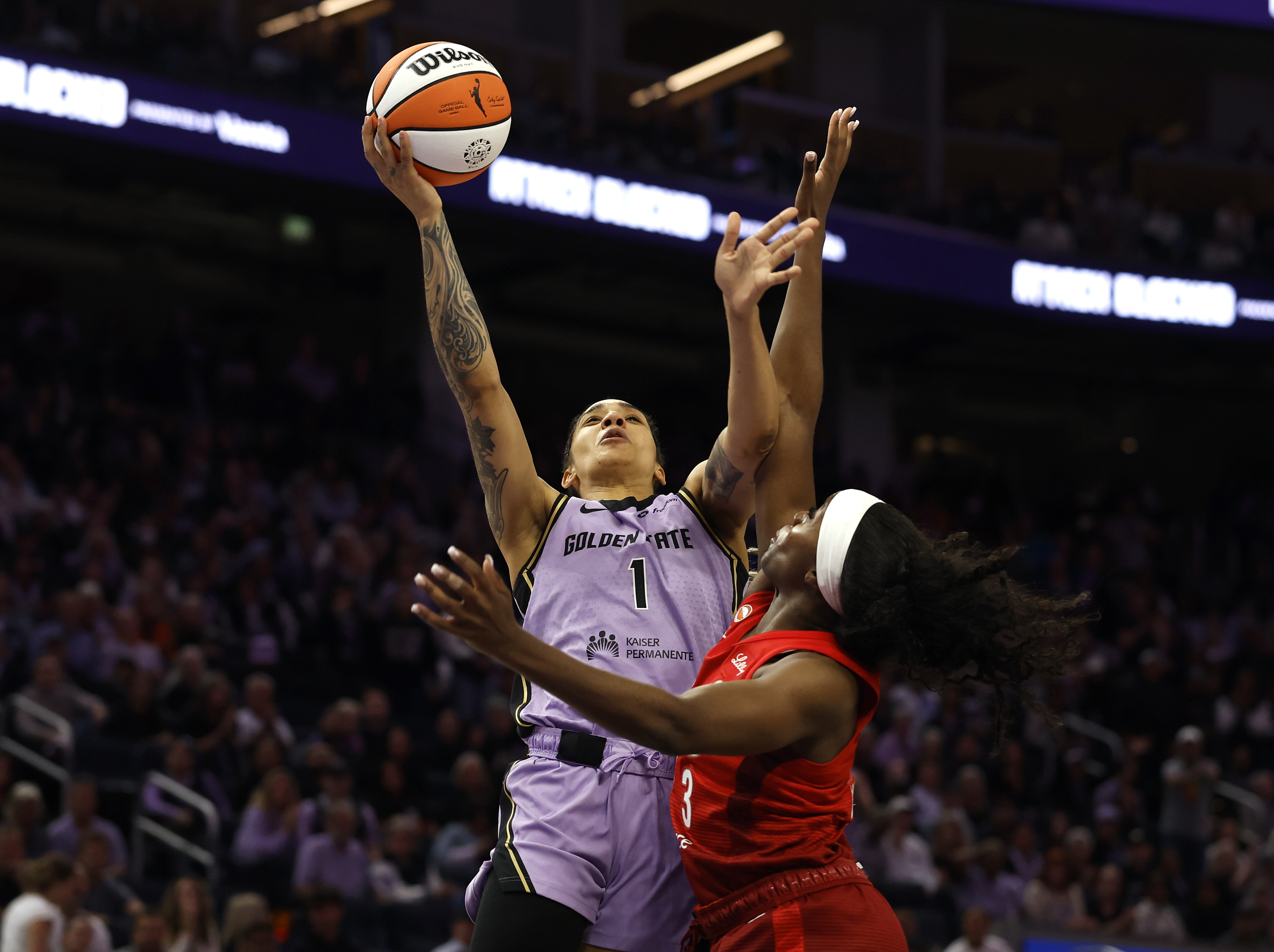 Golden State Valkyries' Gabby Williams (1) is fouled by Indiana...