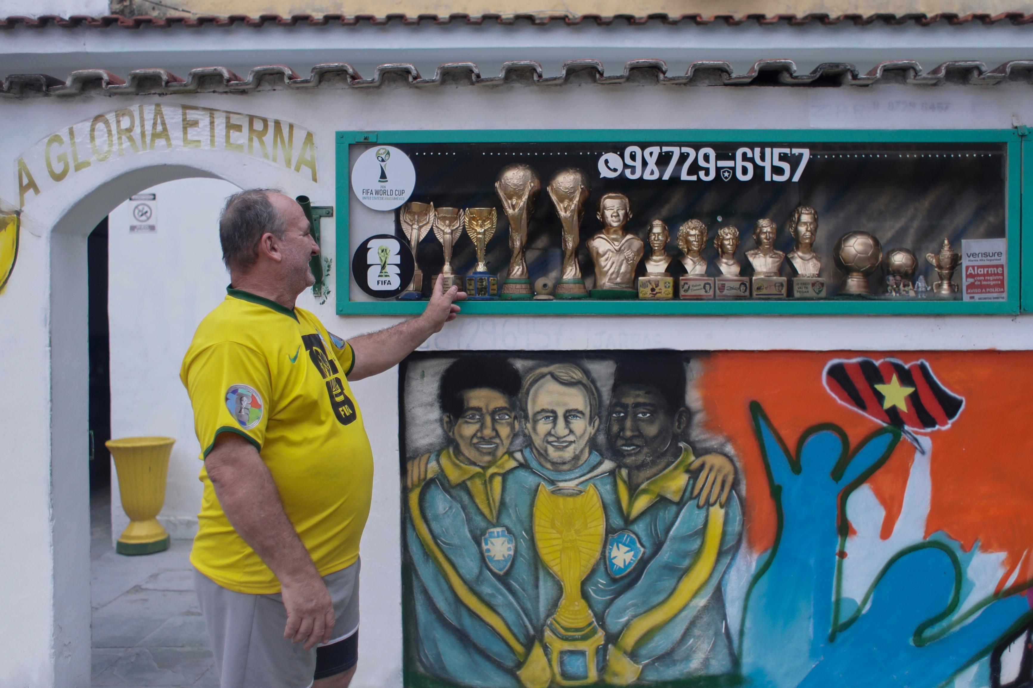 Jarbas Meneghini Carlini shows off FIFA World Cup trophy replicas he made.