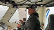 Brand Little prepares to use summon his fishing traps by sending out an acoustic signal that triggers the traps to release a rope and buoy to the surface.
