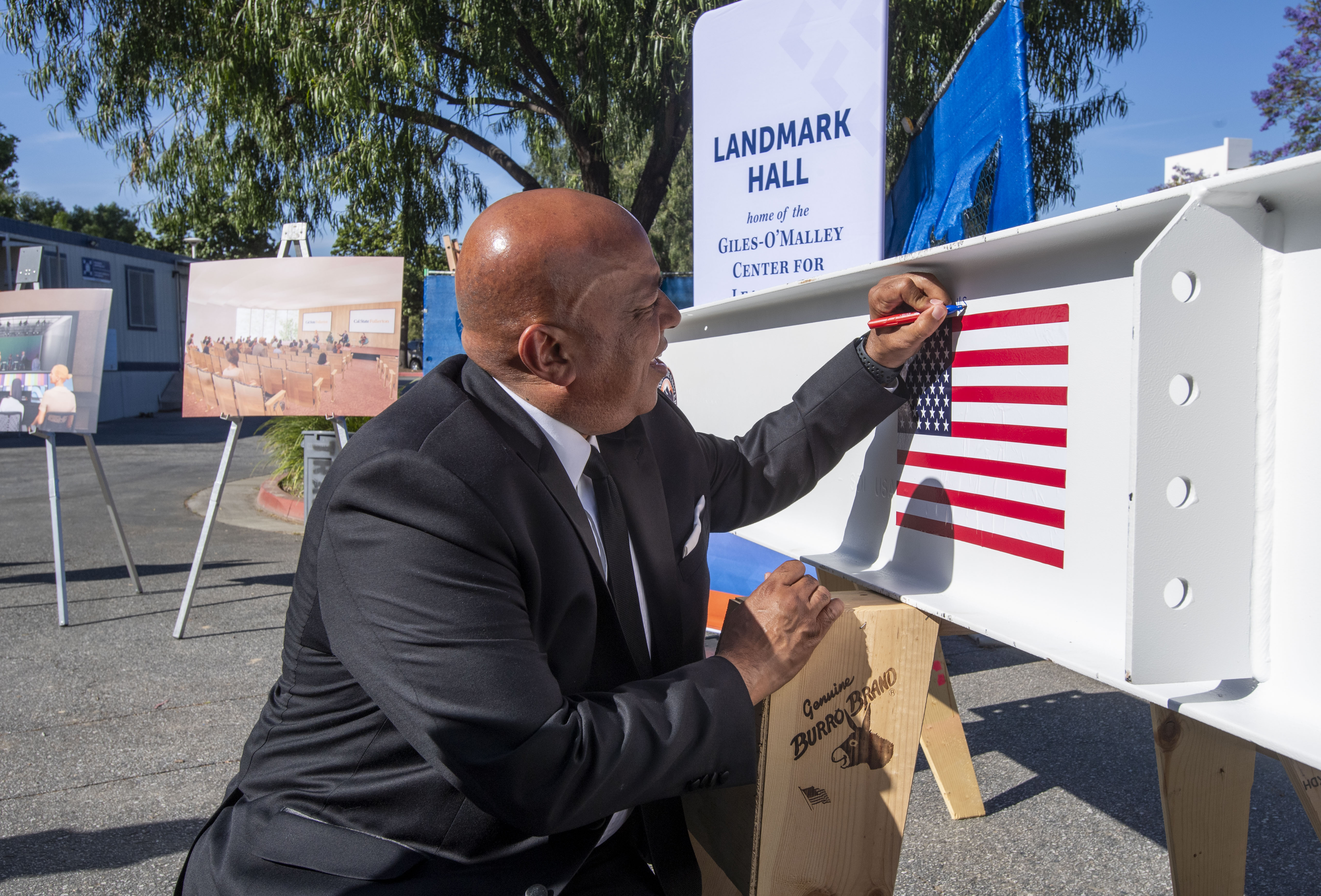 Ronald Rochon, Cal State Fullerton president signs his name on...