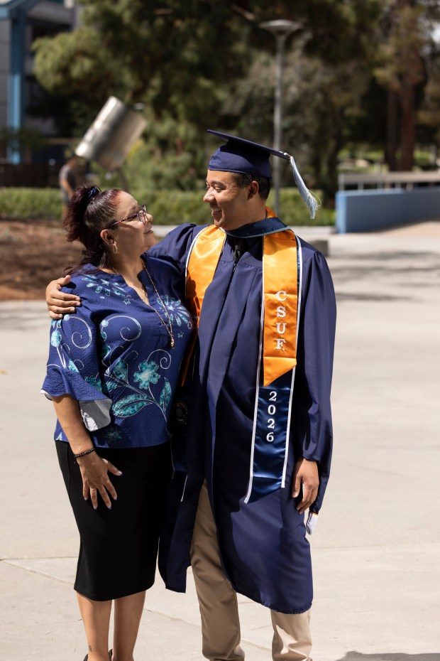 Class of 2026 grad Kevin Greene hugs his mother. (Photo courtesy of Cal State Fullerton)