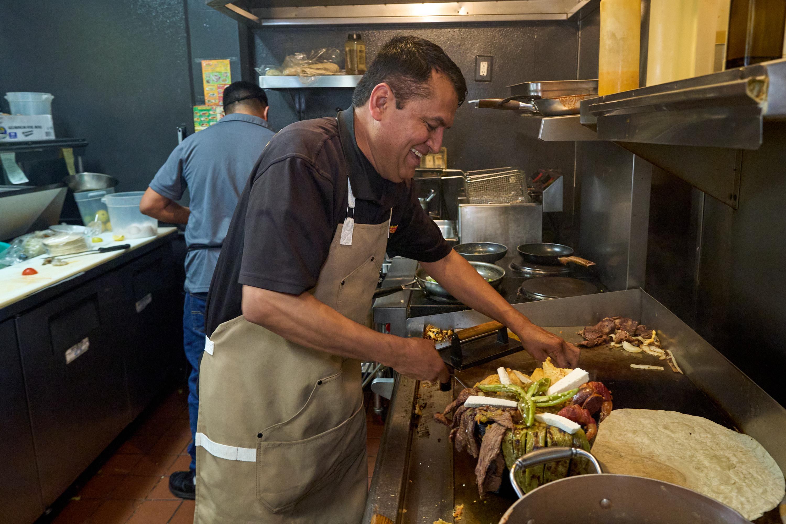 Mexican restaurant owner-chef Marco Mendoza prepares a hot molcajete.