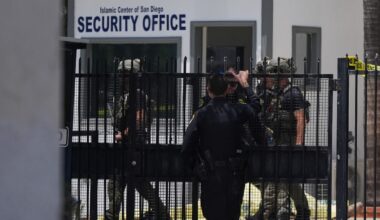 A body is covered with a tarp at the scene of a shooting outside the Islamic Center of San Diego Monday, May 18, 2026, in San Diego. (AP Photo/Gregory Bull)