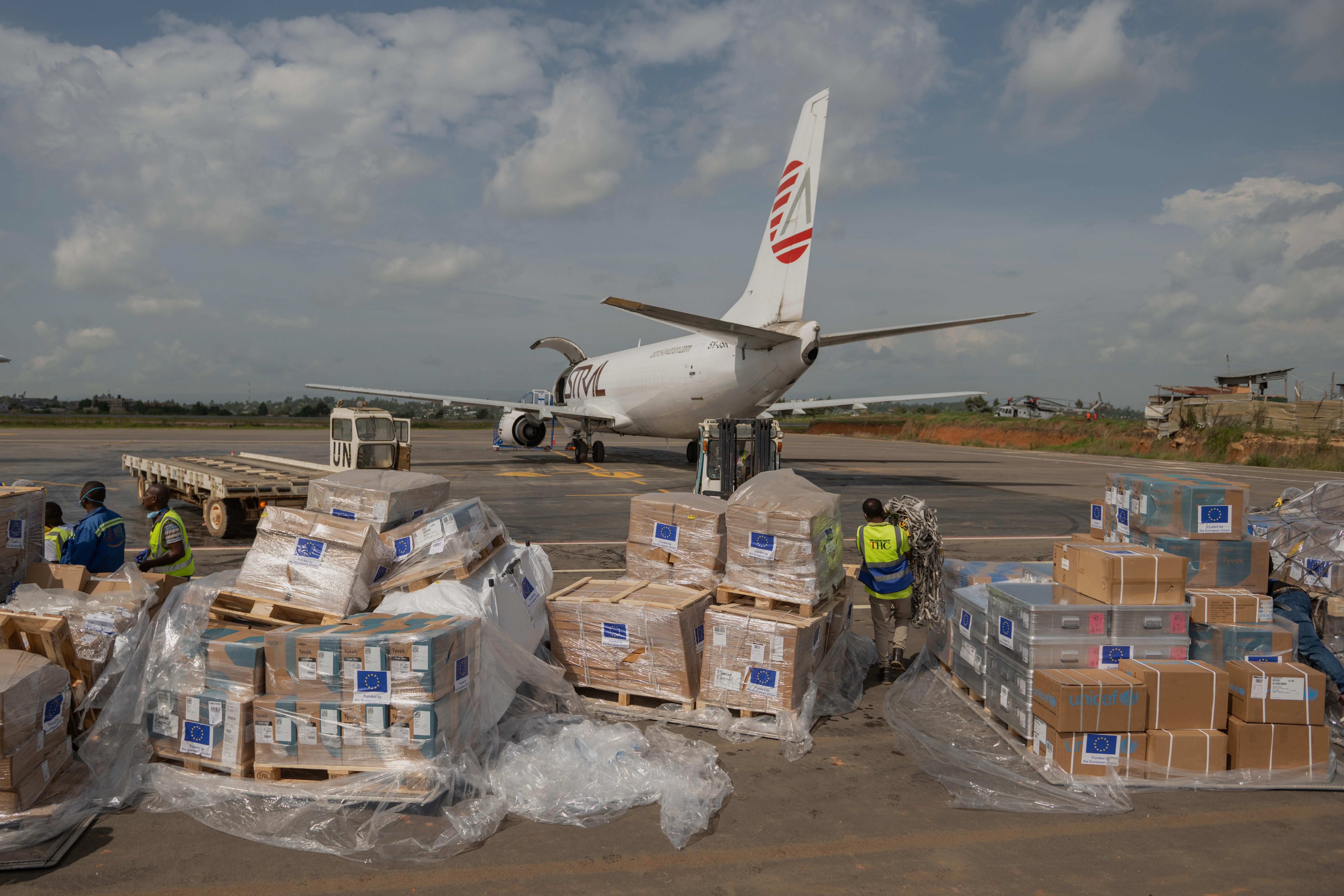 Workers offload medical and emergency supplies donated by the European Union.