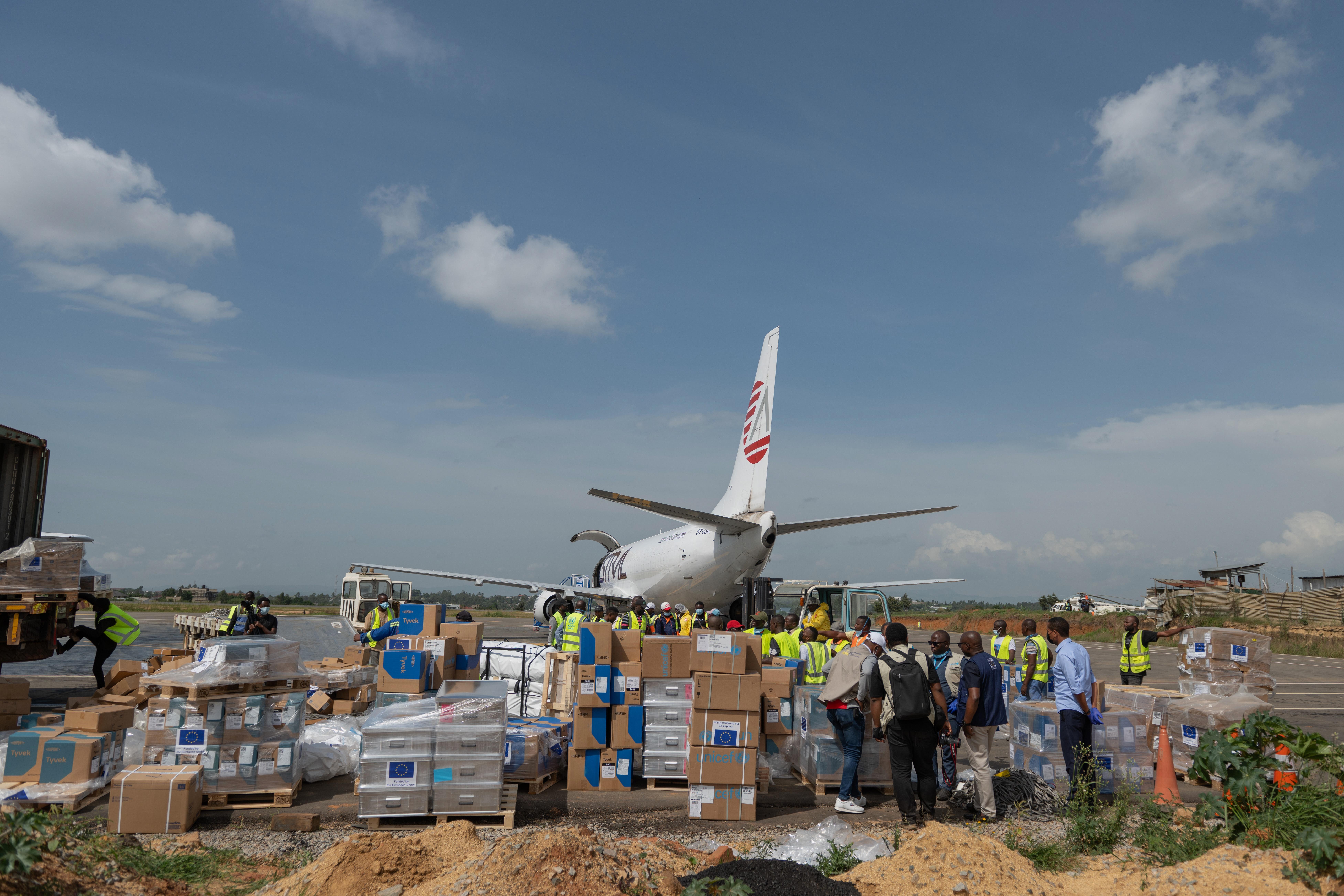 Workers offload medical and emergency supplies donated by the European Union.