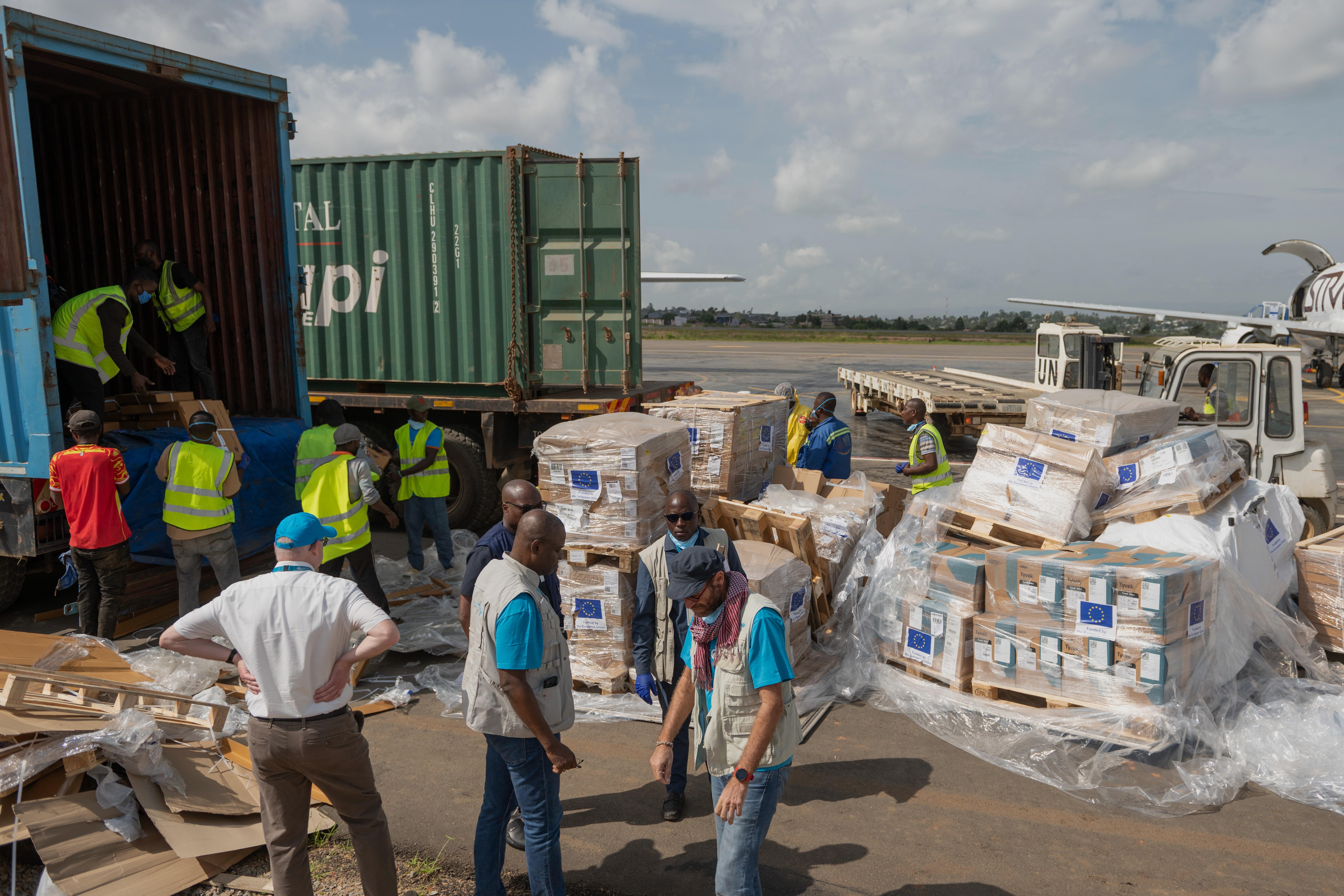 Workers offload medical and emergency supplies donated by the European Union.