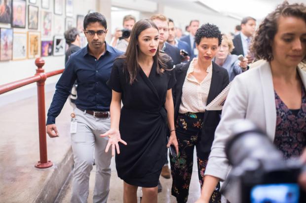 Rep. Alexandria Ocasio-Cortez, D-N.Y., leaves a news conference in the Capitol Visitor Center after responding to negative comments by President Trump that were directed at the freshman House Democrats on Monday, July 15, 2019. Her then-chief of staff, Saikat Chakrabarti, appears at left.