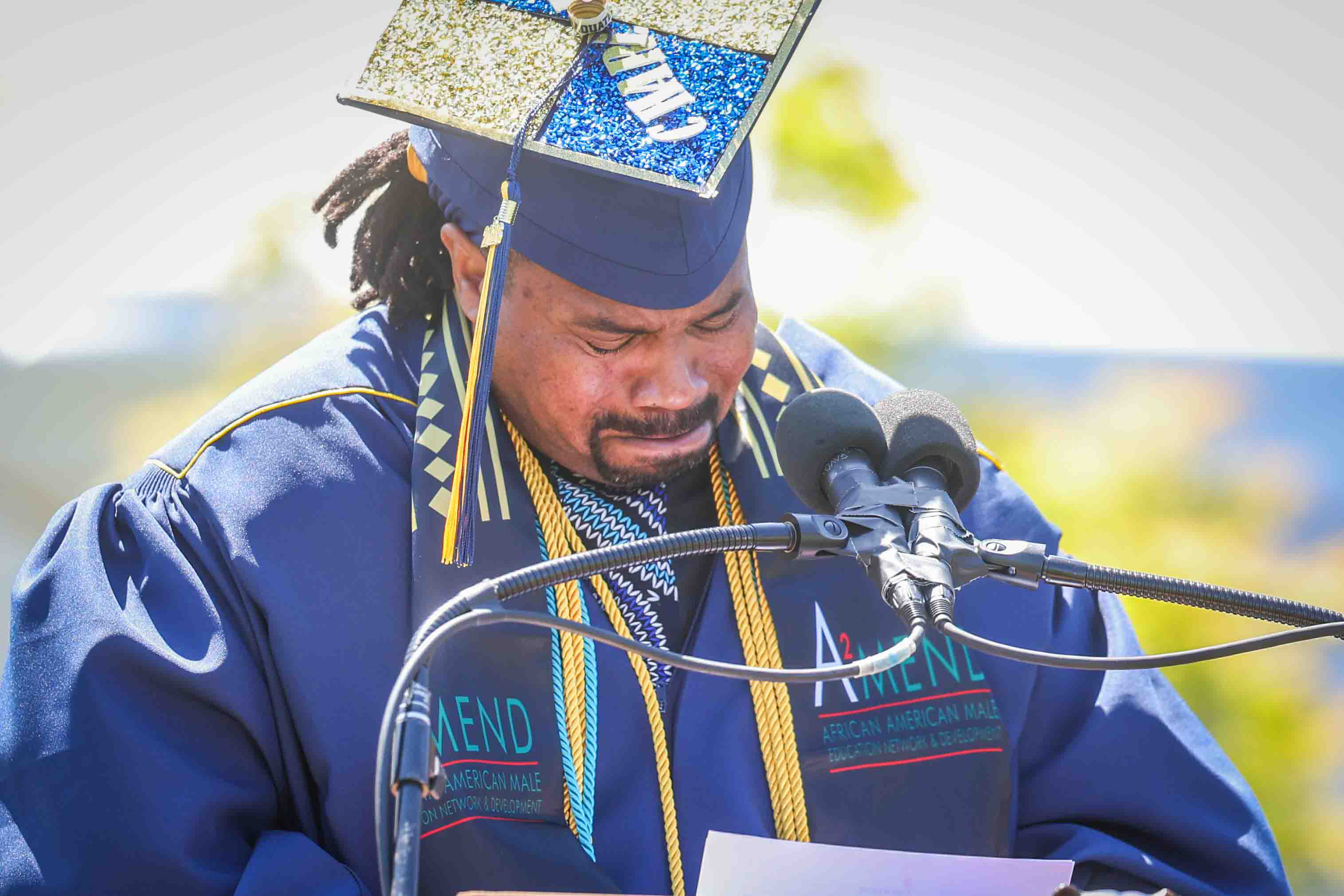 University Medalist Charles Long, 43, gets emotional as he delivers...