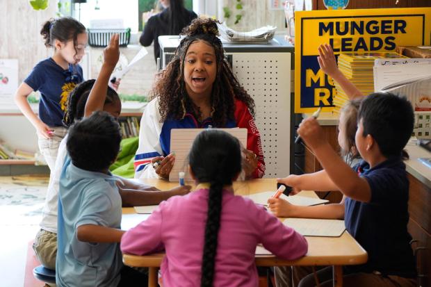 Teacher, Aja Penick, works with first graders at Munger Elementary-Middle School Thursday, May 7, 2026, in Detroit. (AP Photo/Paul Sancya)