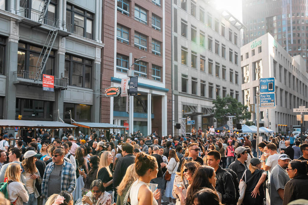 a crowd in the street for a free party