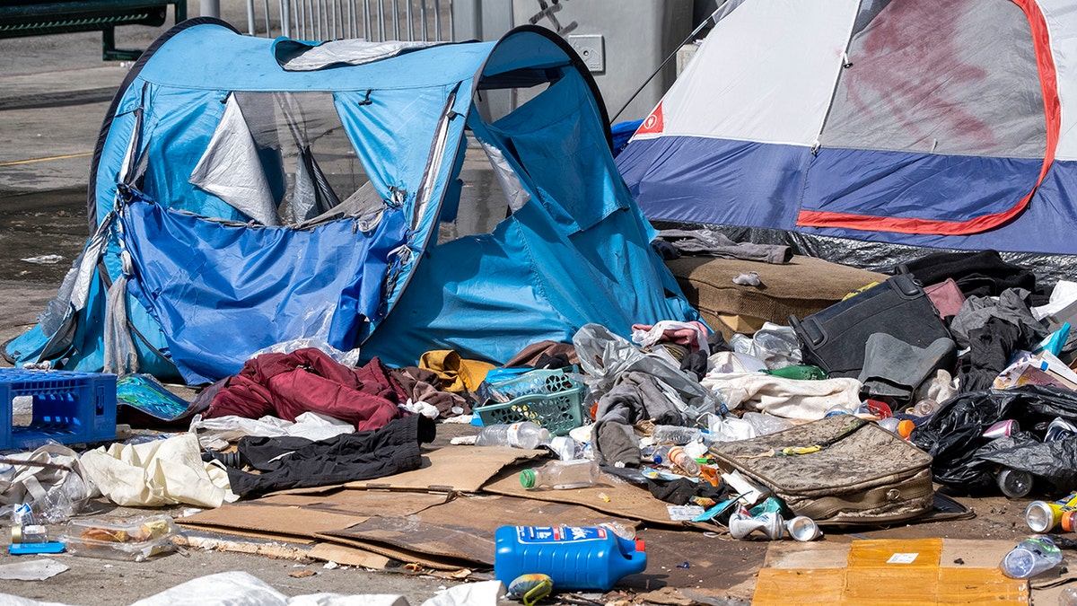 Tents and belongings at a homeless encampment in Toriumi Plaza in Los Angeles