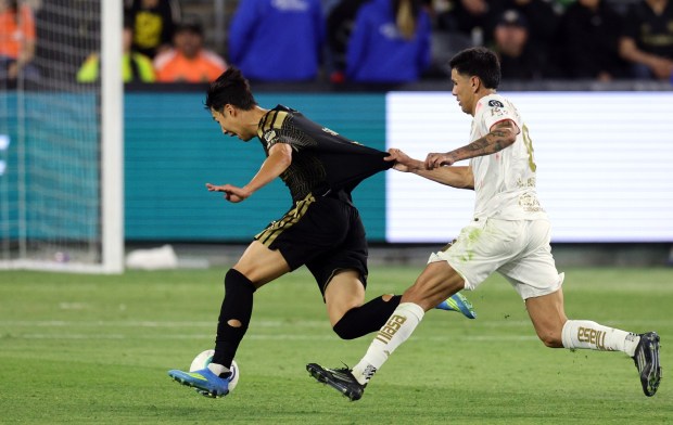 LAFC's Son Heung-Min, left, has his jersey grabbed by Toluca FC's Nicolás Castro as he attacks during the second half of the first leg of a CONCACAF Champions Cup semifinal on Wednesday, April 29, 2026, at BMO Stadium. (Photo by Kevork Djansezian/Getty Images)