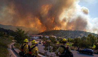 Firefighters monitor the Sandy Fire as it burns close to a residential area on Monday in Simi Valley, Calif. Credit: Apu Gomes/AFP via Getty Images