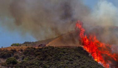 Firefighters work to combat a hotspot in the hills while the Sandy Fire continues to burn near a residential area on Wednesday in Simi Valley, Calif. Credit: Apu Gomes/AFP via Getty Images