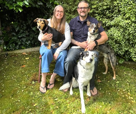 Dr. Leah Isaacson and her husband, Dr. Thomas Minturn, appear with their family dogs, Lou, left, Piper, on ground, and Cheese Sandwich. (photo courtesy of Dr. Leah Isaacson)