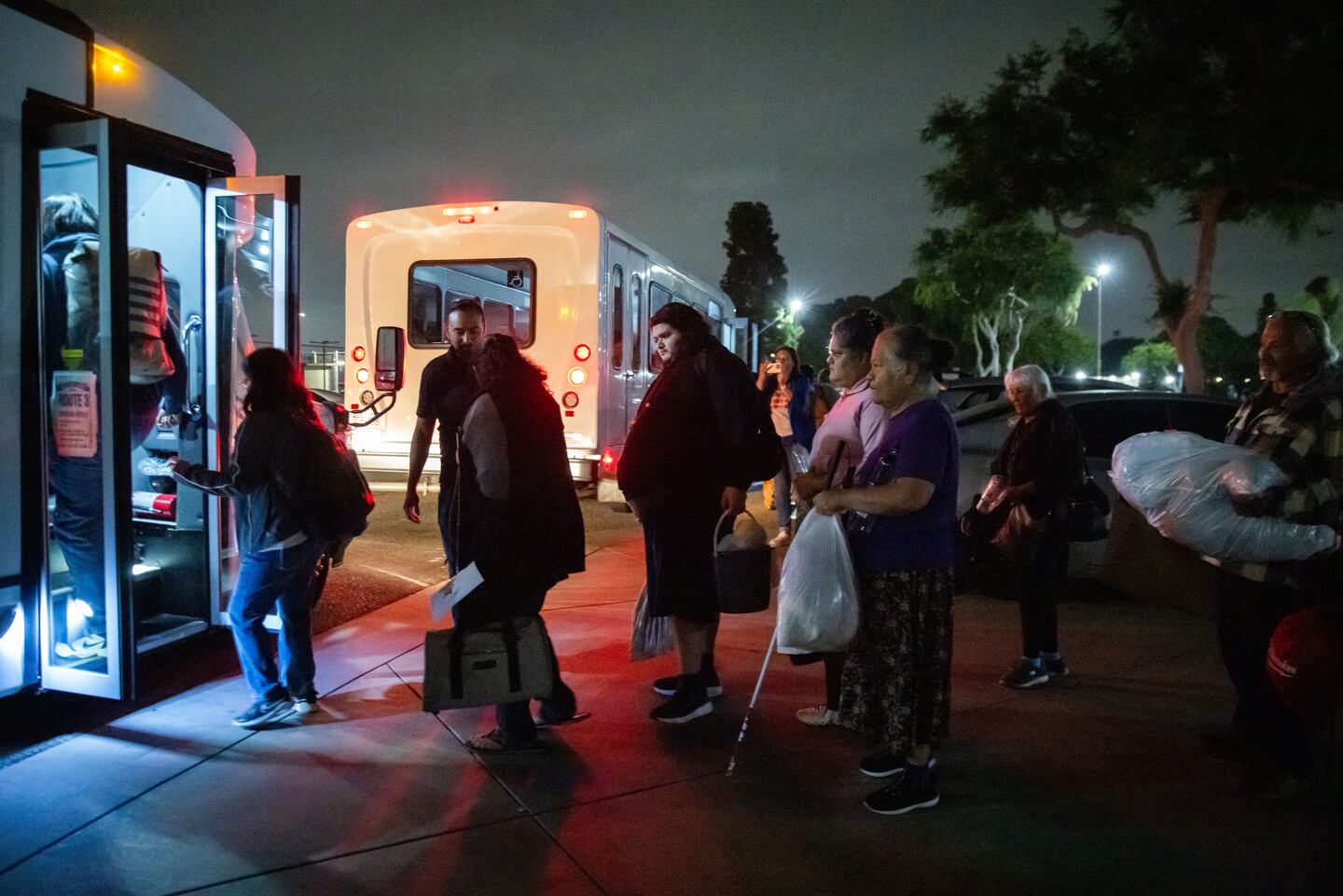 Evacuees from an aerospace chemical plant tank leak move to another shelter after the Garden Grove Sports and Recreation Center closed for the night in Garden Grove, Calif., on May 22, 2026.