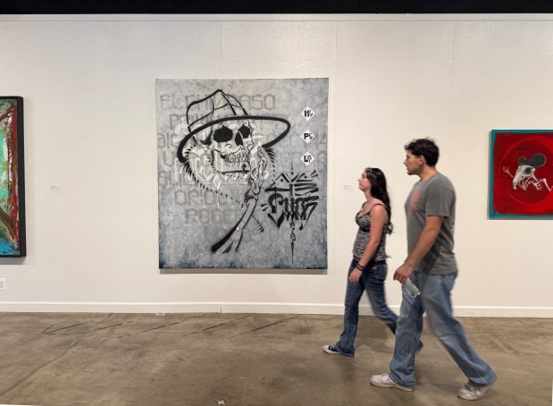 Patrons walk through the Millard Sheets Art Center at the L.A. County Fair on Thursday, May 14 past the painting "Mr. Lucky" by Chaz Bojórquez. (Photo by David Allen, Inland Valley Daily Bulletin/SCNG)