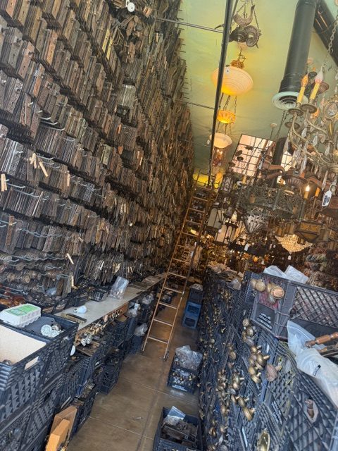 The Loft at Liz’s gallery storage wall filled with vintage hardware and metal objects Los Angeles
