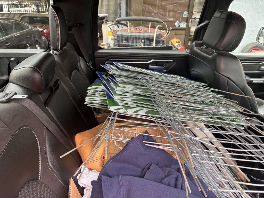 Campaign signs in the back seat of a car.