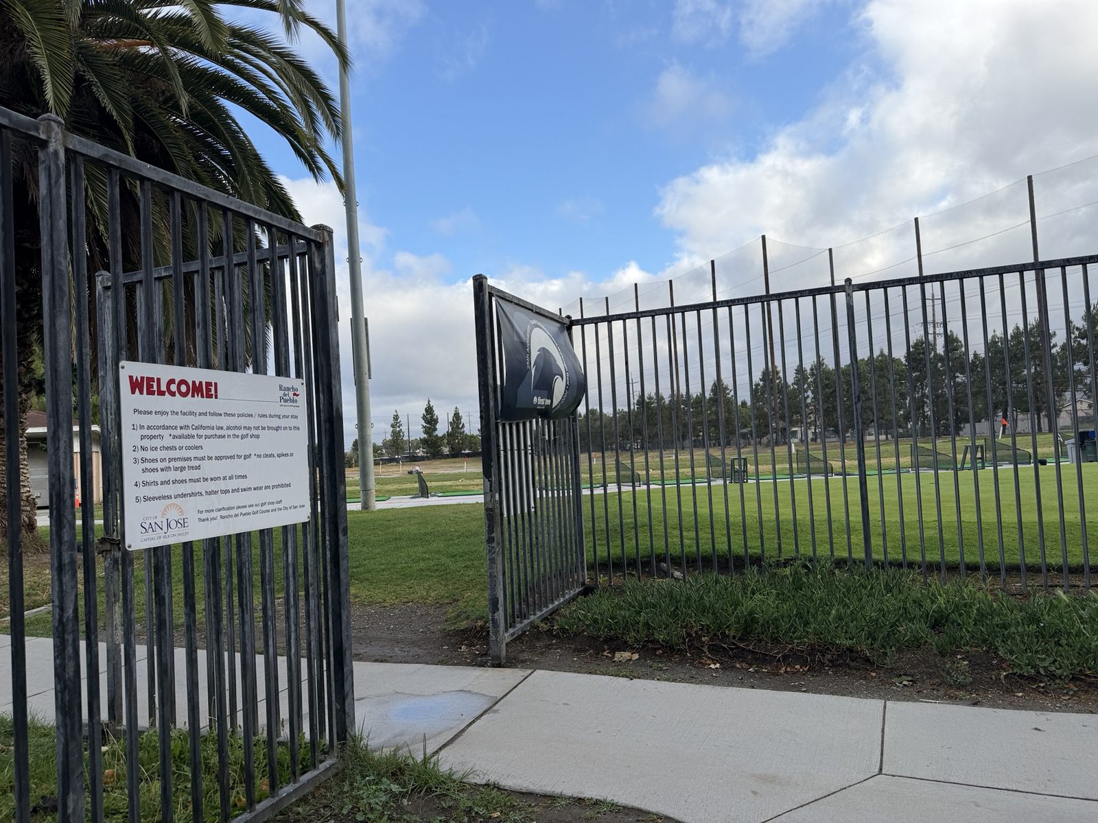 A metal gate around a golf course