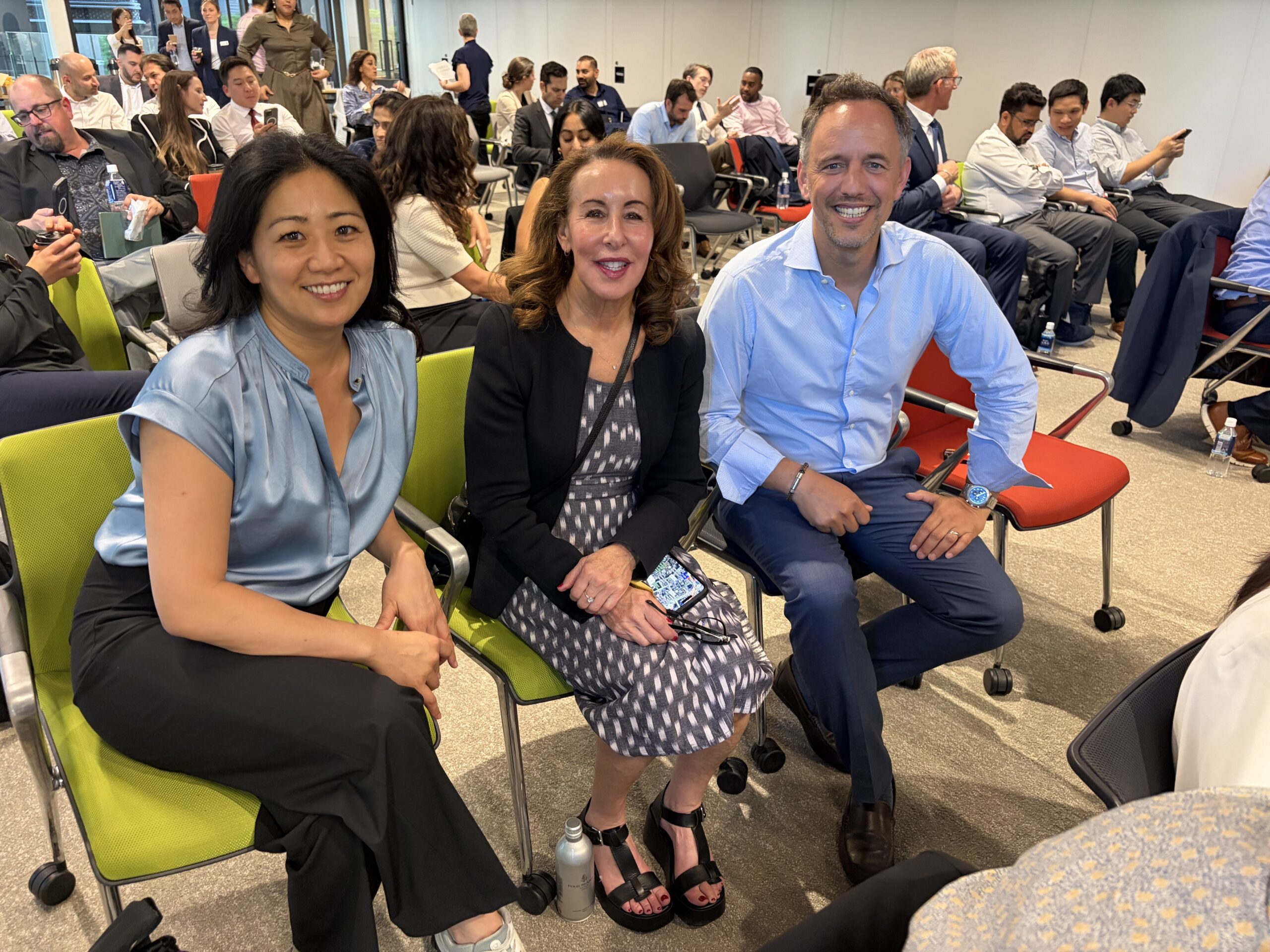 two women and a man sitting on a couch