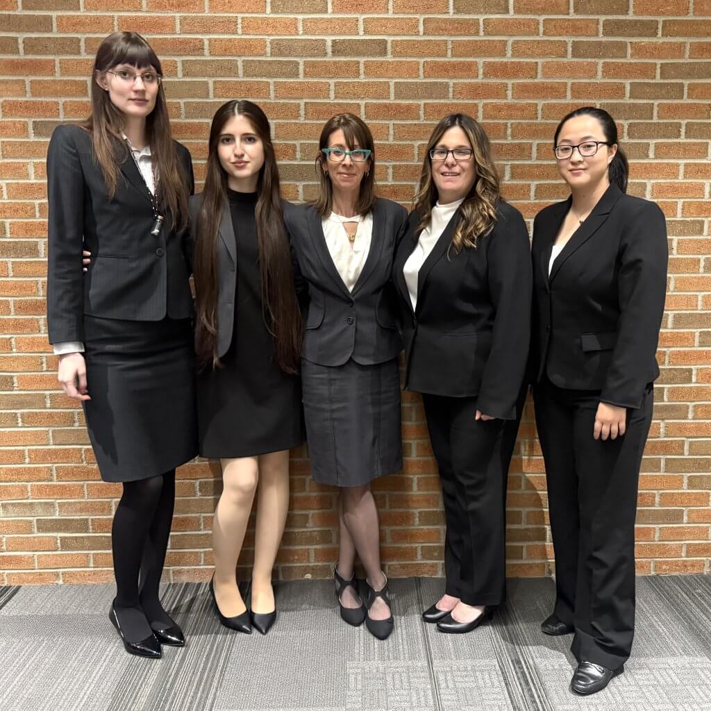 Sociology and philosophy grad Nichole Gideon with Moot Court team standing together