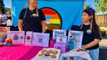 Nadia Keanayub, executive director of Rainbow Spaces, works a booth with her daughter Layla, 10, Saturday, May 30, 2026.