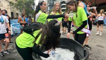 Presley Smith (center handing water bottle) joined other members of the Miss Poway Scholarship Pageant, volunteering, Sunday, to support runners, May 31, 2026.
